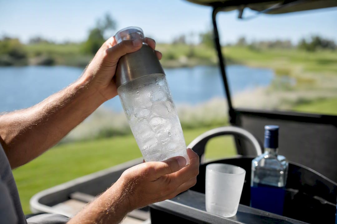 Shaking coffee vodka cocktail in golf cart