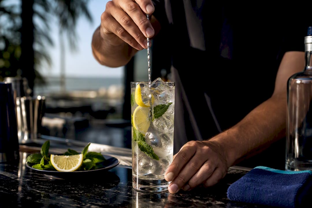 Summer vodka cocktail being mixed at clubhouse bar