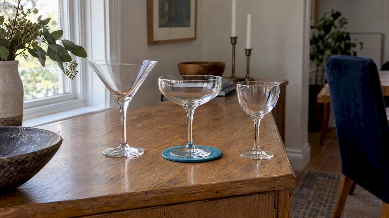 Three distinct martini glass silhouettes on sideboard